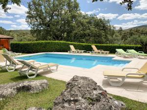 a pool with chaise lounge chairs and a group at Casal Frias in Barreira