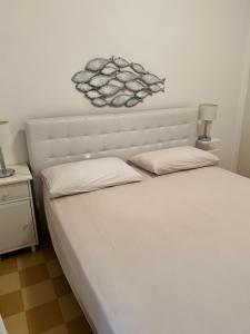 Postel nebo postele na pokoji v ubytování SEABAUDIA1 CON TERRAZZA