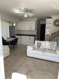 een woonkamer met een witte bank en een keuken bij Wonderful Villa In Oludeniz 2 in Kayakoy