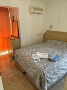 a bedroom with a bed with a pair of shoes on it at Wonderful Villa In Oludeniz 2 in Kayakoy