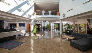 a lobby with a couch and a table in a building at Hotel Meerane in Meerane