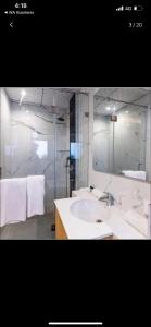 a bathroom with a white sink and a mirror at Balconies & Venue ( The Grand Anukampa) in Jaipur