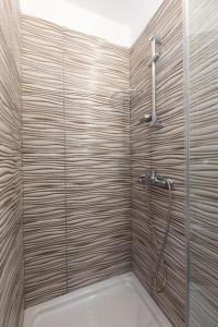 a bathroom with a shower with a glass door at Apartments Hodanić in Krk