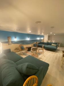 a living room with a green couch and chairs at Canalside Inn in Rehoboth Beach