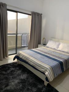 a bedroom with a large bed with a window at URBAN PARK UMHLANGA J001 in Durban
