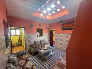 a living room with a couch and a table at Cap sim surf house in Essaouira