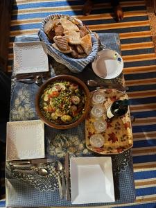 a table with a plate of food and a bowl of food at Cap sim surf house in Essaouira