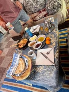 a table with a tray of breakfast foods on it at Cap sim surf house in Essaouira