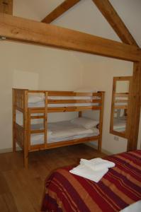 a bedroom with two bunk beds with a bed at Honeysuckle Farm cottages in Glastonbury