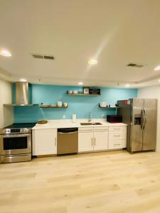 a large kitchen with white cabinets and stainless steel appliances at Canalside Inn in Rehoboth Beach