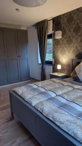 a bedroom with a large bed with a window at Ferienwohnung Sonne in Stahlhofen