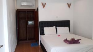 Postel nebo postele na pokoji v ubytování Edo Homestay & Restaurant