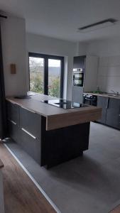 a large kitchen with a large island in the middle at Ferienwohnung Sonne 