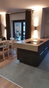 a kitchen with a table and a dining room at Ferienwohnung Sonne in Stahlhofen