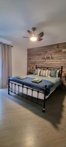 a bedroom with a large bed with a wooden headboard at Wally's Edge 20acre Farm Stay in Rawson