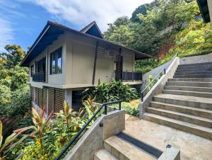 a house with stairs leading up to it at Perch El Nido's Seaview Villas overlooking Marimegmeg in El Nido