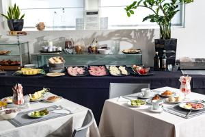 two tables with plates of food on them at Hotel Nuova Mestre in Mestre