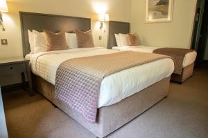 A bed or beds in a room at Arklow Bay Hotel