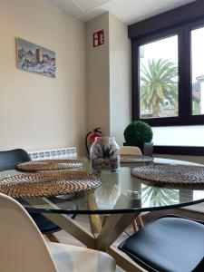 a dining room with a glass table and chairs at Lapaserina-A in Arenas de Cabrales