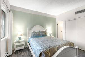 a bedroom with a large bed and a window at Sand & Sea: Turtle Cove (214) in Seaside