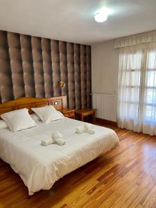 a bedroom with a large bed with two towels on it at Hotel Eriste in Eriste