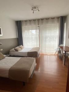 A bed or beds in a room at Pensión Residencia Fornos