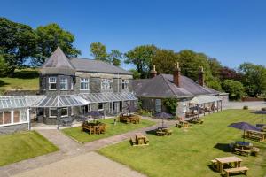 an aerial view of a house with tables and umbrellas at Broadway House in Laugharne