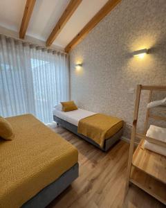 um quarto com 2 camas e uma janela em Douro Pateo House em Vila Nova de Gaia
