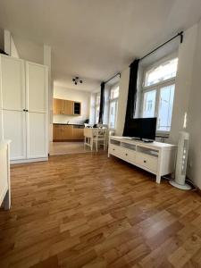a large living room with a hard wood floor at R&L Apartment Karl-Heine-Strasse OG in Leipzig
