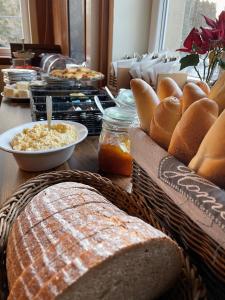 a table topped with baskets of bread and other foods at Horský Hotel Dobrá Chata in Stachy