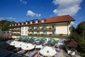 an aerial view of a hotel with tables and umbrellas at Best Western Premier Bayerischer Hof Miesbach in Miesbach