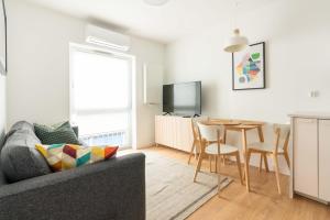 a living room with a couch and a table at Aparthotel Weissa 7 in Krakow