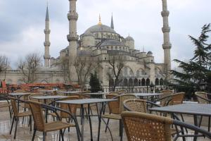 a row of tables and chairs in front of a mosque at Hotel SultanHill in Istanbul
