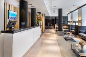 a lobby of a hotel with couches and a reception desk at Catalonia Plaza Mayor in Madrid