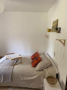 a bedroom with a bed with a table and a lamp at Chez Cathy et Philippe in Vérargues