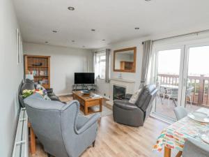 a living room with two chairs and a fireplace at Bay View in Paignton