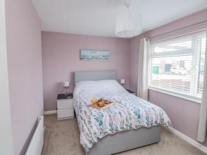 a bedroom with a bed and a window at Bay View in Paignton