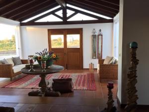 a living room with a table with flowers on it at Refúgio do Monte in Odemira