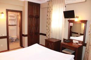 a hotel room with a bed and a mirror and a mirror at Hotel SultanHill in Istanbul