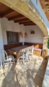 a wooden table and chairs on a patio at Casa Playa Javea in Jávea