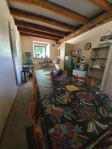 a kitchen with a table with a patterned table cloth at Gîte du Nouveau Monde in Langoëlan