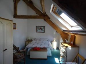 a bedroom with a bed in a attic at Gîte du Nouveau Monde in Langoëlan +12 photos