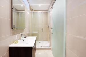 a white bathroom with a shower and a sink at London Choice Apartments - South Kensington - Mews House II in London +35 photos
