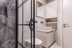 a bathroom with a toilet and a glass shower at Centr in Istanbul