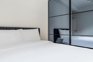 a bedroom with a white bed and a mirror at Centr in Istanbul