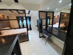 a room with two bunk beds and a desk at Burgundy McKinley Place Service Apartment in Manila