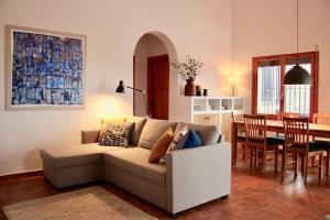- un salon avec un canapé et une salle à manger dans l'établissement Casa El Boqueron:rust en relaxen met een prachtig uitzicht!, à Cómpeta