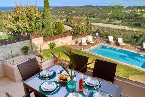 a dining table with a bowl of fruit on top of a house at Polemarchi Mystique Villa in VoukoliaÃ­