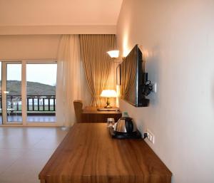 a living room with a table with a tea kettle on it at Kumbhal Exotica Resort Kumbhalgarh in Kumbhalgarh