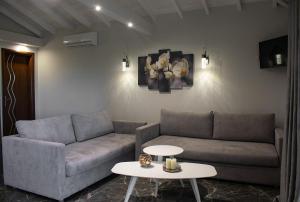 a living room with a couch and a table at Stamos Apartments and Studios in Vourvourou